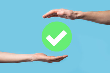 Hand holds green icon Check mark,Check Mark Sign, Tick Icon,right sign,circle green checkmark button,Done.On dark background.Banner.Copy space.Place for text.