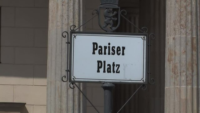 Pariser Platz sign in front of Brandenburg Gate in Berlin, Germany.