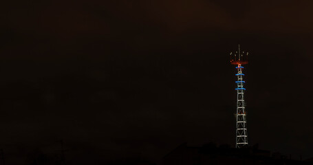 Panoramic view of illuminated TV broadcasting tower at night in Minsk. Night scenery with TV Tower in Minsk.