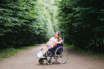 Attractive female wheelchair user in stylish summer dress looking at camera with calm face during...
