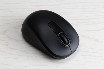 black wireless computer mouse on white table