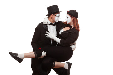 Portrait of two mime artists performing, isolated on white background. Woman is sitting on the mans knee. Symbol of close friendship, relations, trust relationship