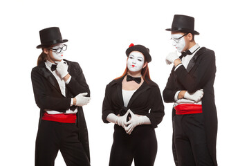 Portrait of three mime artists performing, isolated on white background. Mimes stand thinking. Symbol of finding solution, brainstorming, idea