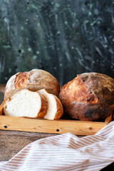Homemade sourdough bread. Wooden background, side view.