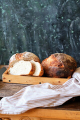 Homemade sourdough bread. Wooden background, side view.
