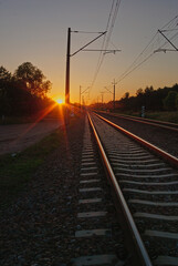 Fototapeta na wymiar railroad tracks at sunset in the mountains