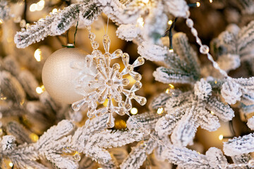 Christmas and New Year background, tree decorated with lights and crystal New Year decoration. Soft selective focus.