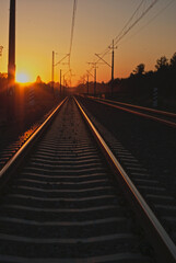 Fototapeta na wymiar railroad tracks at sunset in the mountains