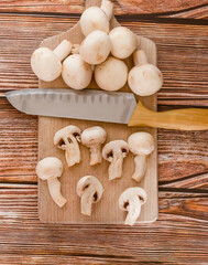 Fresh porcini mushrooms on a cutting board. On a tree background