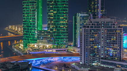 Fototapeta premium Promenade and Dubai cityscape seen from Dubai marina night timelapse. Aerial view to JBR district and Bluewaters Island behind