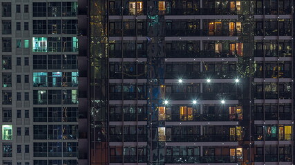 Fototapeta na wymiar Night view of exterior apartment colorful building timelapse with windows