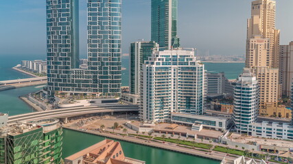 Promenade and canal seen from Dubai marina timelapse. Aerial view to JBR district and Bluewaters Island behind