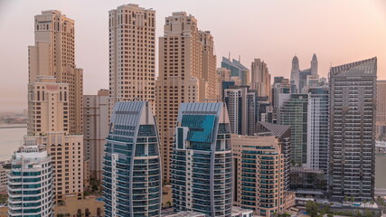Fototapeta na wymiar Dubai Marina skyscrapers and JBR district with luxury buildings and resorts aerial timelapse