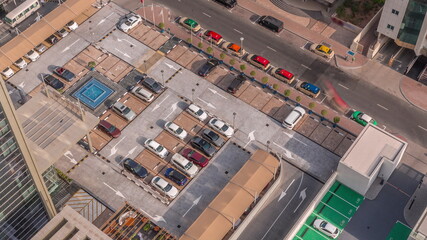 Aerial view of car crowded parking lot near apartment buildings all day timelapse.
