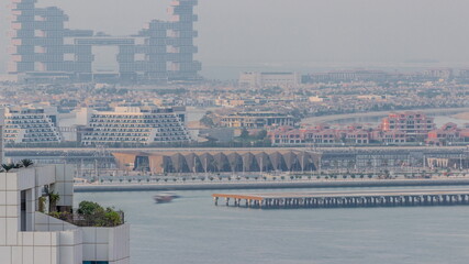 Aerial view of many luxury villas and hotels on the Palm Jumeirah island in Dubai timelapse. UAE