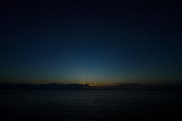 Fototapeta na wymiar Twilight sky with stars at the lake.