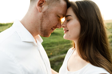Fototapeta premium close-up of a young couple who stands face to face with smiles on their faces. happy guy with a girl. portrait of lovers