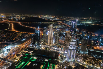 Fototapeta premium Dubai, United Arab Emirates – December 14, 2021, the people visiting the the 24th and 25th floor of Burj Khalifa at night and shopping souvenirs at the shop