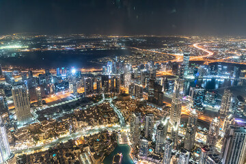 Naklejka na ściany i meble Dubai, United Arab Emirates – December 14, 2021, the Arial skyline view of Dubai city at night from at the top of Burj Khalifa at night