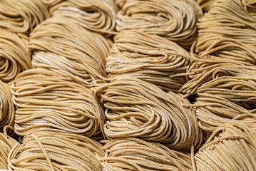  Dried egg noodles in wooden blocks isolated on white background.