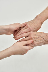 Cropped of grandma and granddaughter holding hands