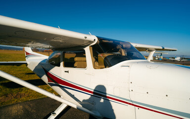 Fototapeta na wymiar Small sport airplane Cessna 150 on standing on a runway.Single-engine turboprop airplane