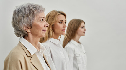 Obraz premium Row of serious caucasian three female generations