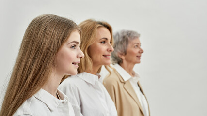 Row of smiling caucasian family of three females