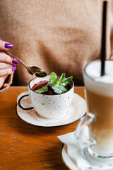 woman eating berry dessert in cup