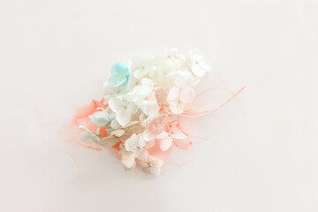 Creative image of pastel blue and pink Hydrangea flowers on artistic ink background. Top view with copy space