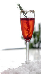 red christmas mimosa with fresh berries and rosemary in a tall glass