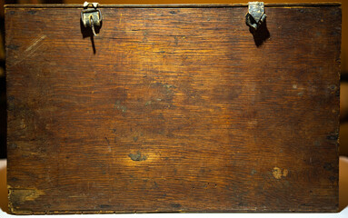 The texture of the old wood is brown. An old wooden box, a place for text.Antique wooden box.