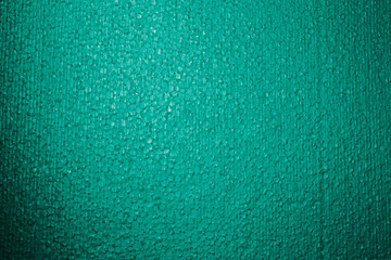 Textured background. Styrofoam in green light. Polystyrene foam close-up. Lots of small and large bubbles. New Year color backdrop. Wallpaper with copy space. Building material. Macro. Rough surface - obrazy, fototapety, plakaty