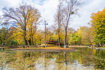 The lake from the Roman park in the autumn surrounded by colored trees, Romania