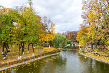 Fototapeta premium The lake from the Roman park in the autumn surrounded by colored trees, Romania