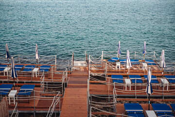 Fototapeta premium Santa Maria di Leuca, Italy-June 2021: deck chairs on the beautiful coastiline in the southern part of Puglia