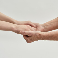 Grandma and granddaughter holding hands each other