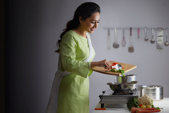 Young woman cooking vegetable in the kitchen