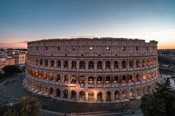 Panoramic image of Colosseum (Coliseum) in Rome, Italy, at sunrise and sunset. 
