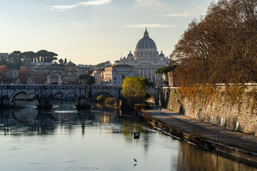 Fototapeta premium Rome, Italy. Vatican dome of Saint Peter Basilica (Italian: San Pietro) and Sant'Angelo Bridge, over Tiber river. 