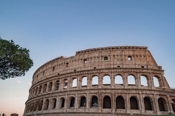 Fototapeta na wymiar Panoramic image of Colosseum (Coliseum) in Rome, Italy, at sunrise and sunset. 