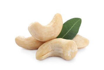 Tasty organic cashew nuts and green leaf isolated on white