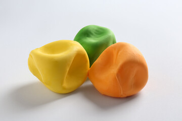 Different color play dough on white background