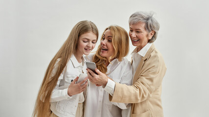 Pleased females watching smartphones of each other