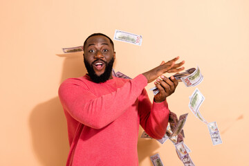 Photo of funky millennial brunette guy spend money wear pink sweater isolated on beige color background