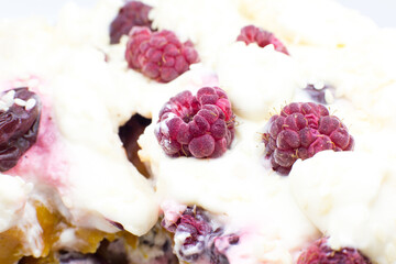 Tasty homemade cake with cream, fresh cherries and raspberry.
