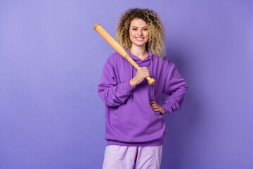 Photo of funny pretty woman wear sweatshirt playing baseball smiling isolated violet color...