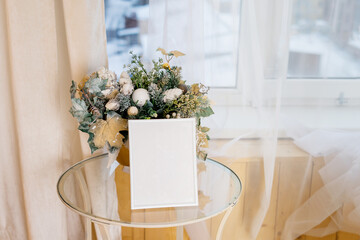 Christmas photo frame mock up template with decoration on wooden table.