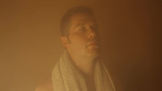 Handsome man in the sauna. Spa and health procedures.