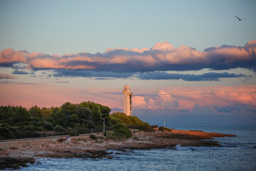 Beautiful view of a lighthouse by the sea at sunset in Alcossebre, Spain